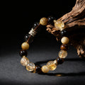 Beaded bracelet with black, yellow, and brown beads on a dark background