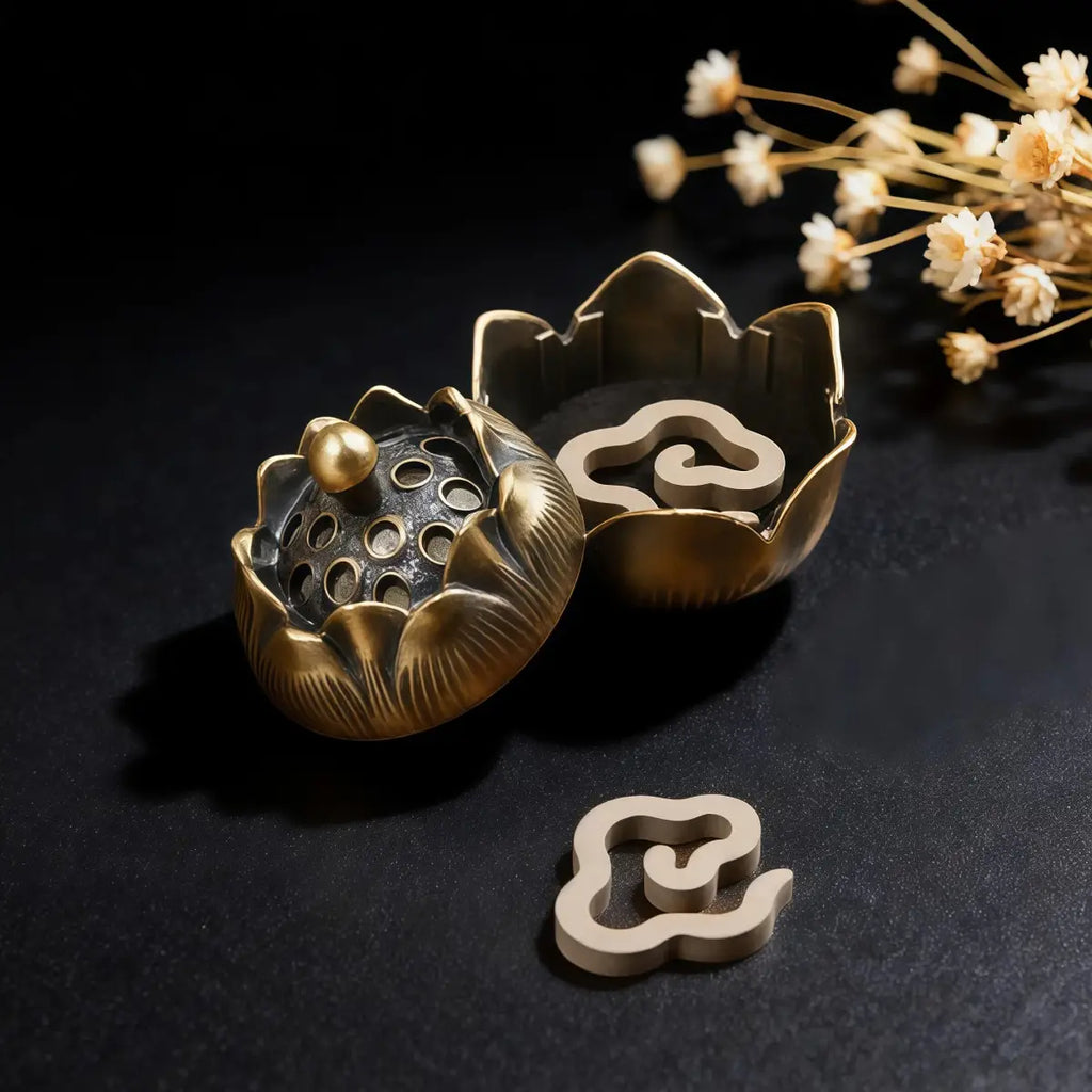 Decorative brass incense holder with floral design on a black background