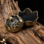 Decorative bronze incense burner on a wooden surface