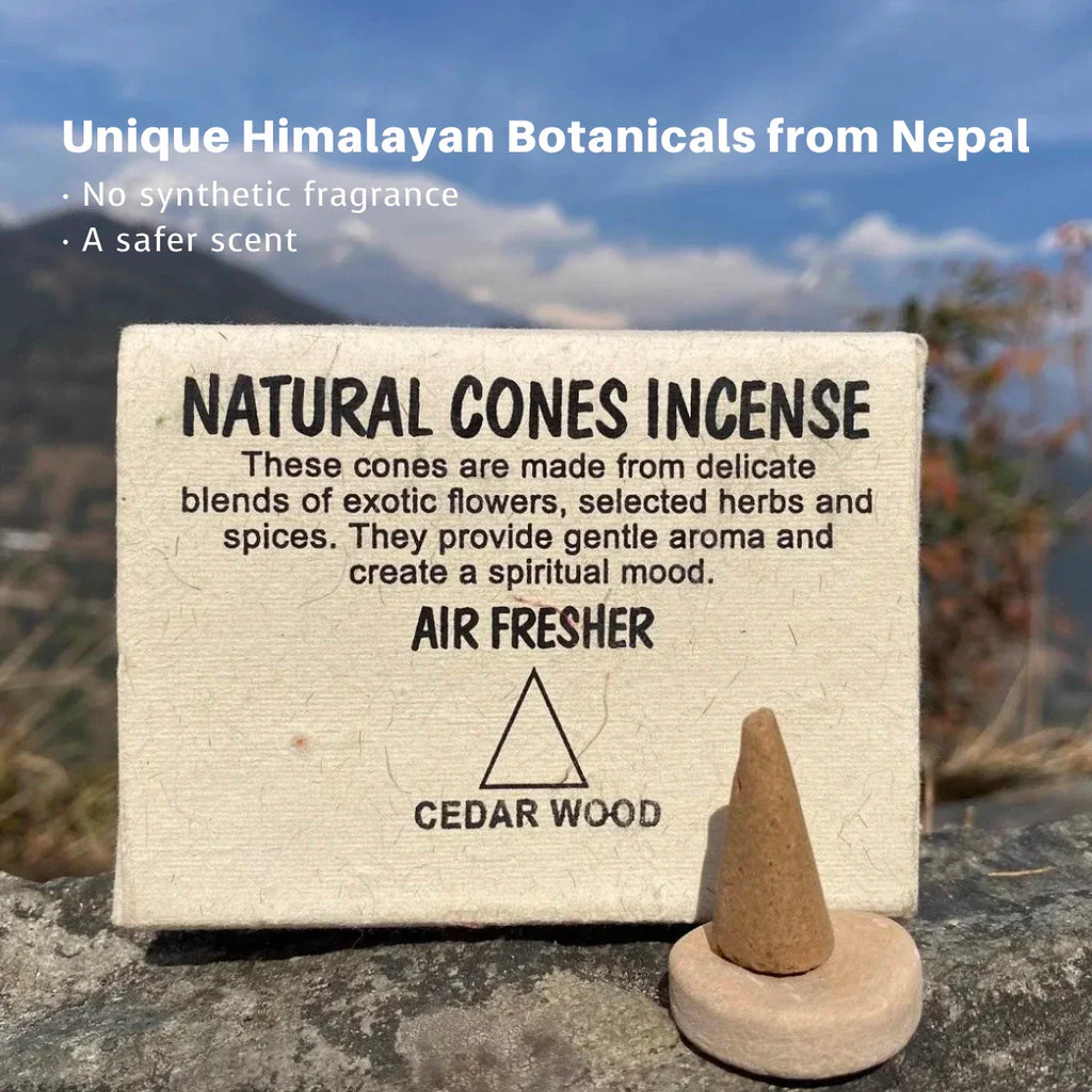 Box of natural cones incense with a cone on a rock, mountainous background