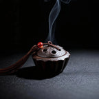 Ceramic Lotus Pod Mini Incense Burner with smoke on a dark background