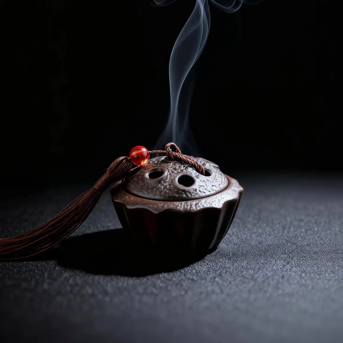 Ceramic Lotus Pod Mini Incense Burner with smoke on a dark background
