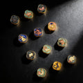 Set of colorful zodiac stone stamps on a dark surface