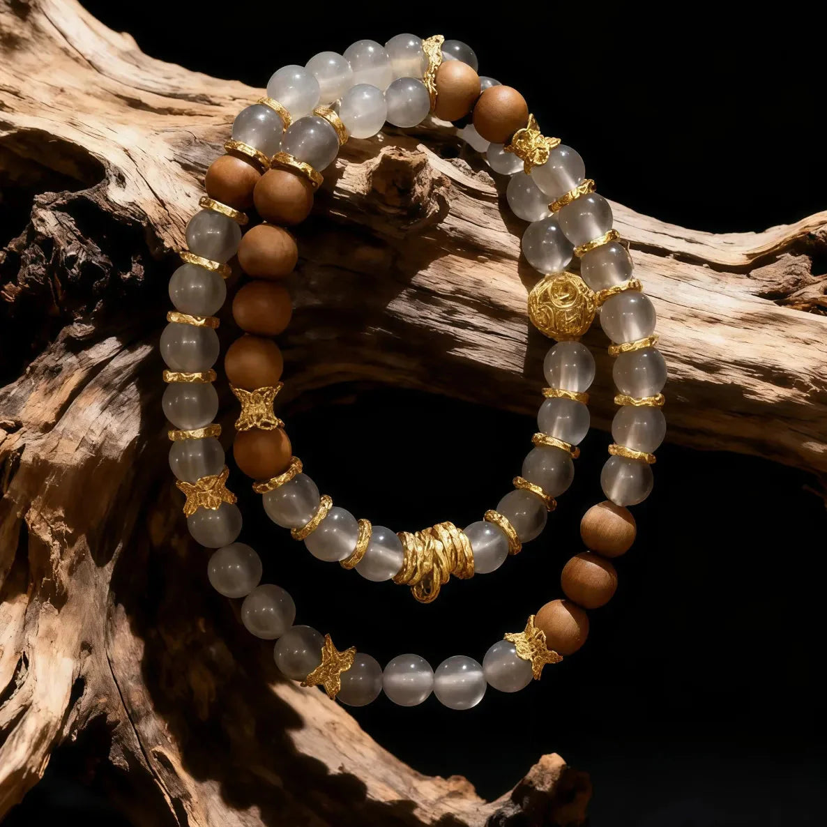 Stack of beaded bracelets with gold accents on a wooden surface