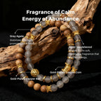 Bracelet with GrayAgate and gold accents on a dark background, labeled with stones' names and benefits.