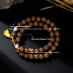 Tibetan incense beaded bracelet with gold foot and pearl, labeled on a dark background