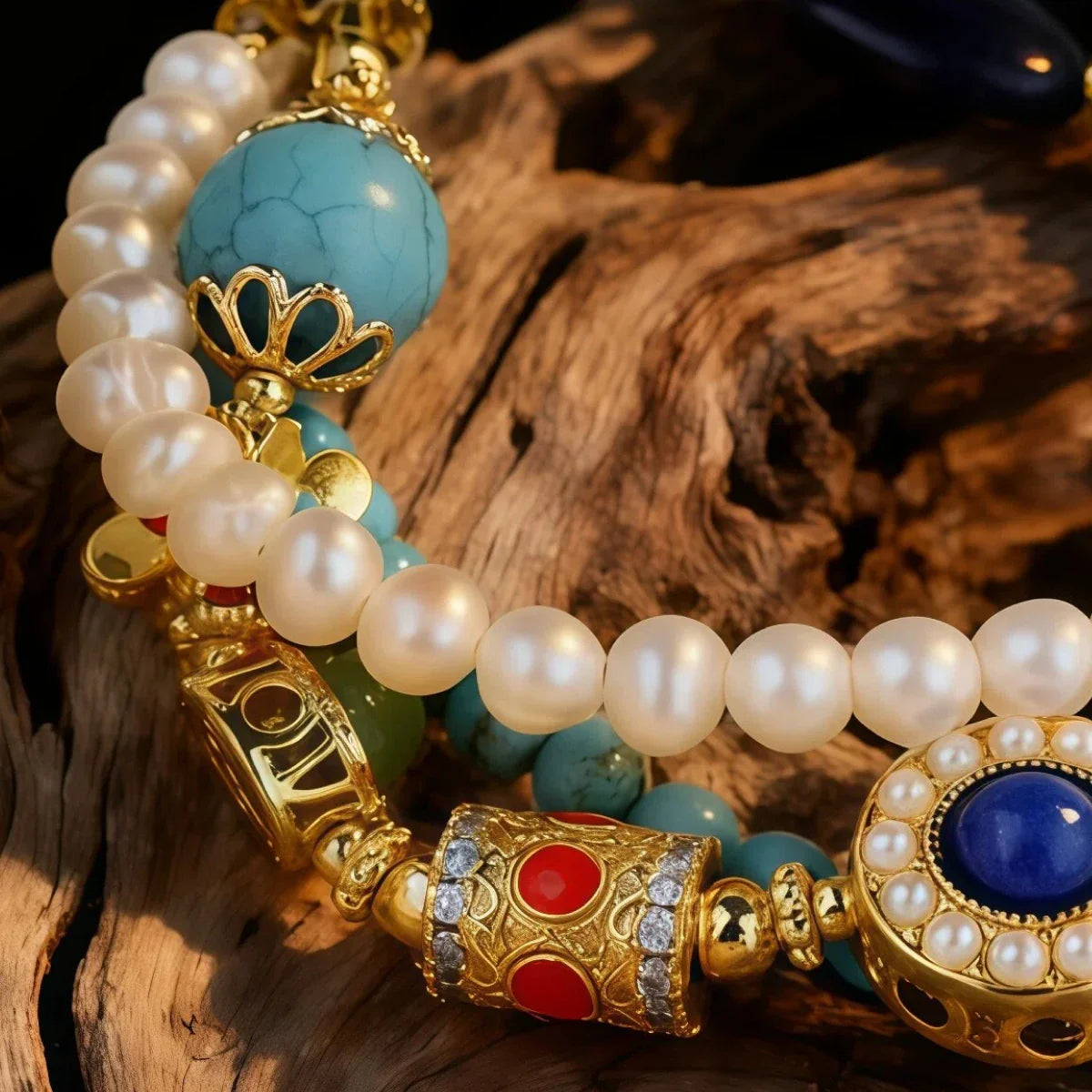 Pearl and gemstone bracelet with gold accents on a wooden surface