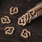 Tibentan cloud-shaped incence slices on a dark wooden surface