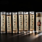 Row of tibetan cloud incense slices in the clear cylindrical containers with scents labels on a dark background