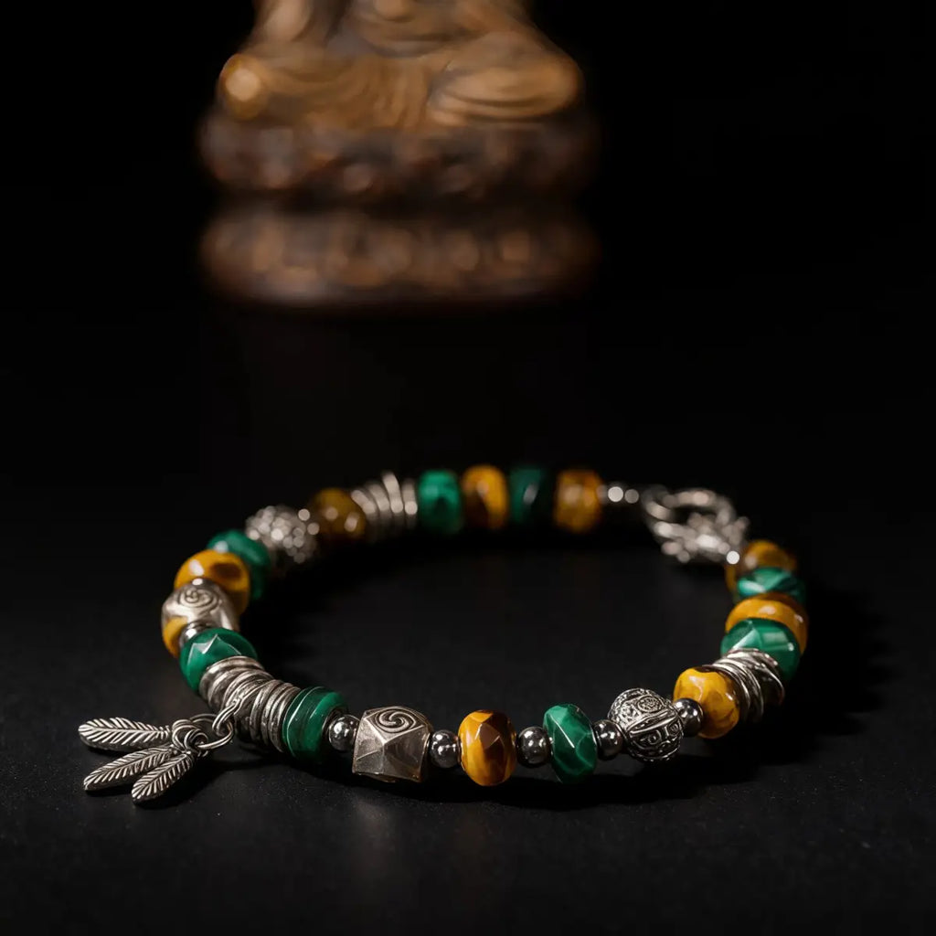 Tibetan Bracelet with green, yellow, and silver beads on a dark background