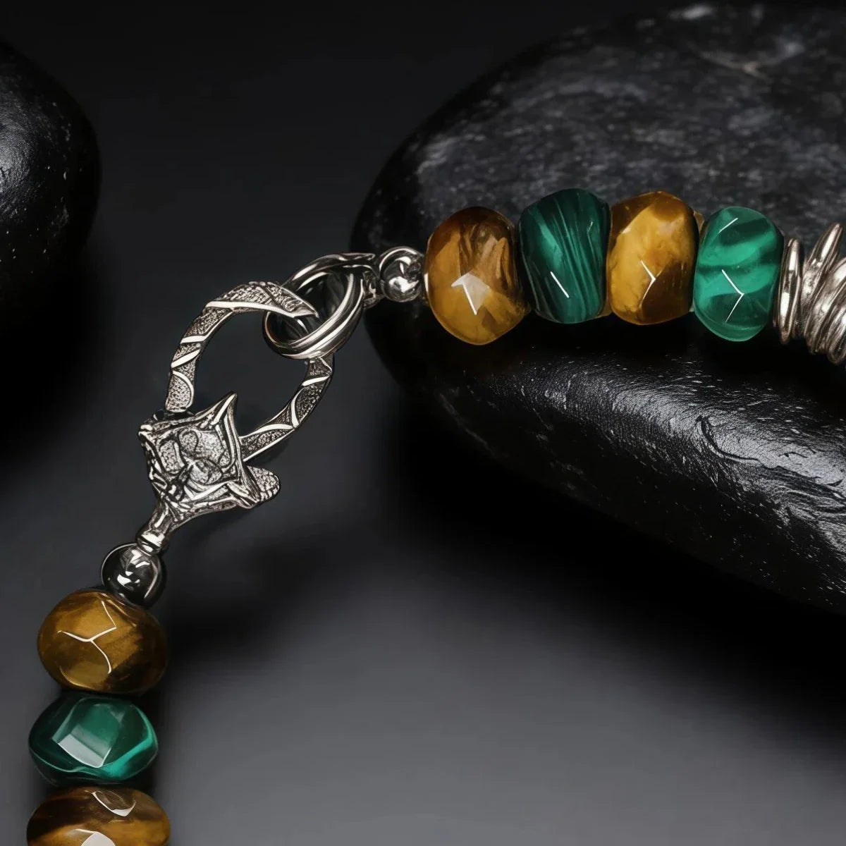 Tibetan Bracelet with green and brown beads and a silver star-shaped charm on a dark background