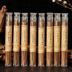 Row of Himalayan Handcrafted incense sticks in clear tubes with labels on a dark background