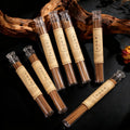 Set of Himalayan Handcrafted incense sticks in transparent tubes with brown labels on a dark background
