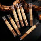 Set of Himalayan Handcrafted incense sticks in transparent tubes with brown labels on a dark background
