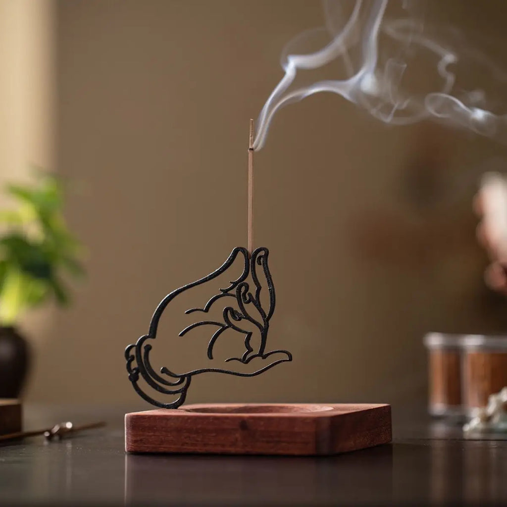 Balance Himalayan Handcrafted Incense stick with smoke on a wooden holder against a blurred background